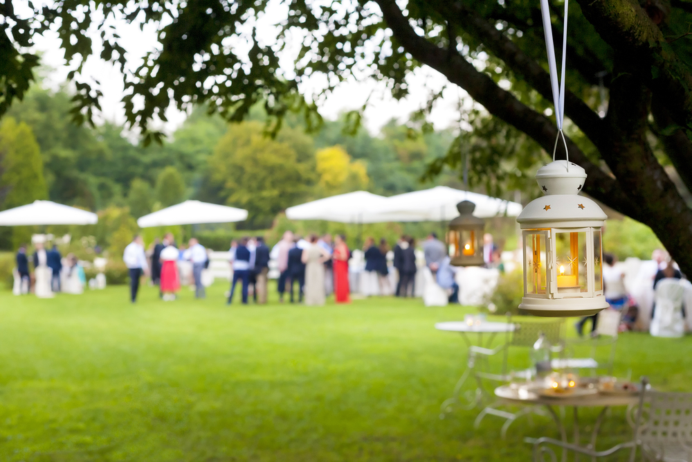 wedding guests at an outdoor reception with tents