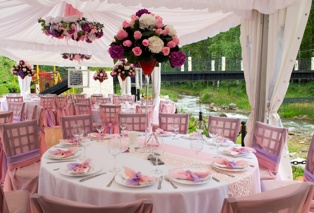 a wedding tent decorated for the reception with tables and chairs