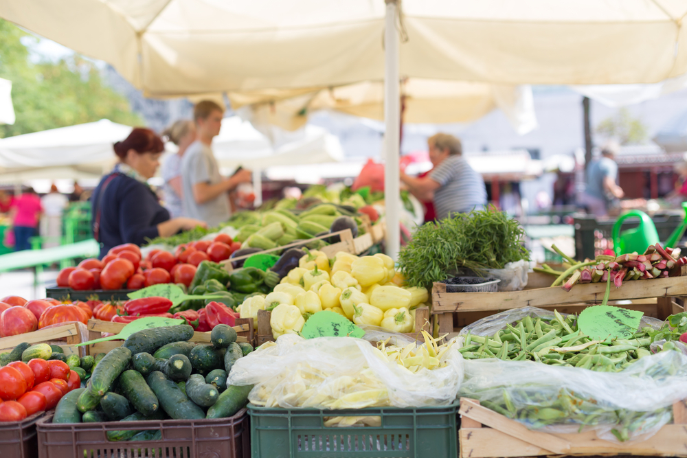 a farmer’s market with tents covering the stalls