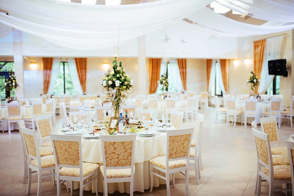 an event tent decorated for an outdoor wedding reception