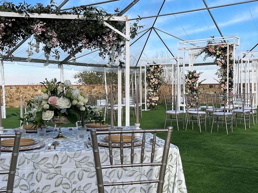 tables and a rental tent set up at Bella Collina Clubhouse for a wedding