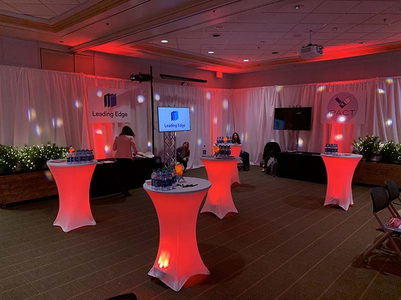 Cocktail tables with under lighting set up for corporate event