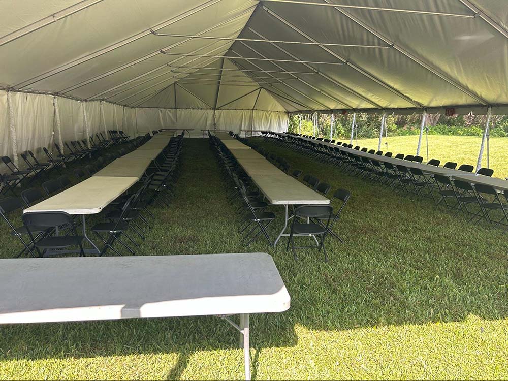 Tables under large outdoor tent rental